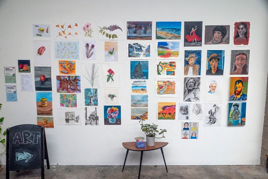 A wall with art works mounted